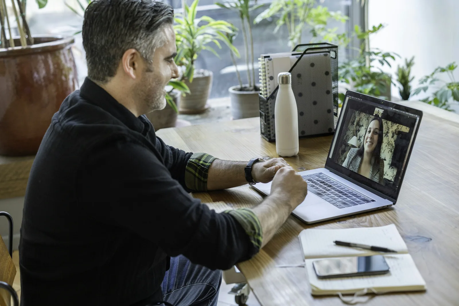Man on a video call with his physician from his desk at home